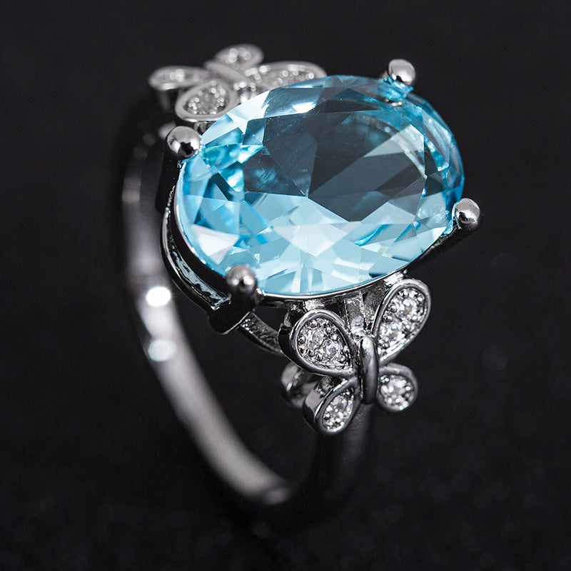 Eleganter Damenring mit großem blauem Zirkon & Schleifen-Design