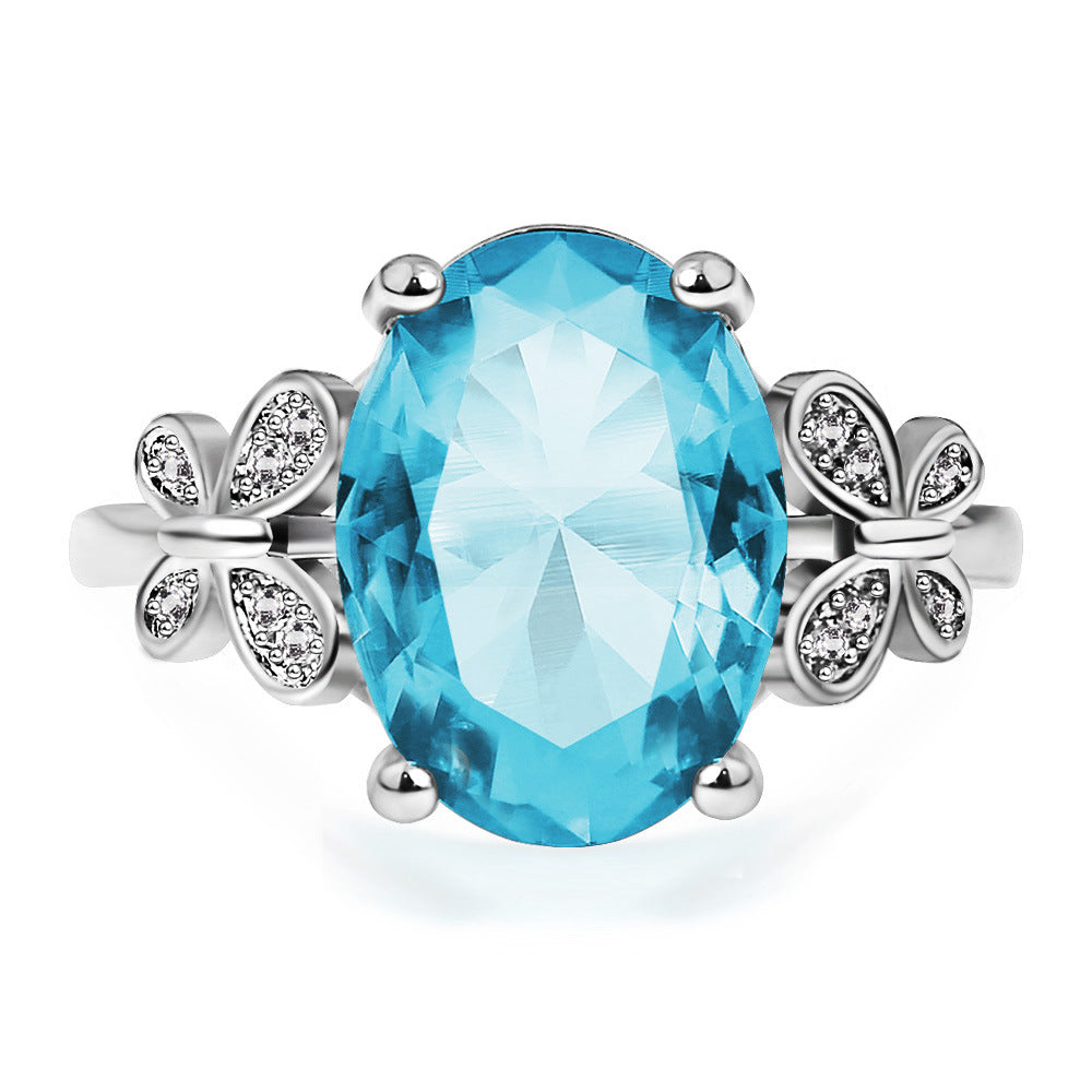 Eleganter Damenring mit großem blauem Zirkon & Schleifen-Design