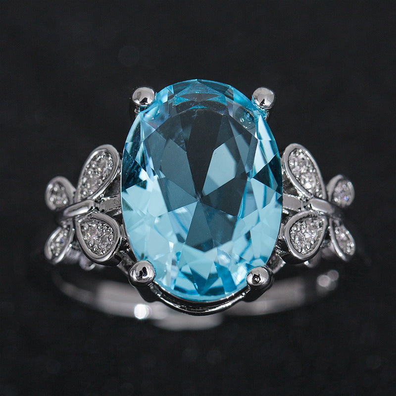 Eleganter Damenring mit großem blauem Zirkon & Schleifen-Design