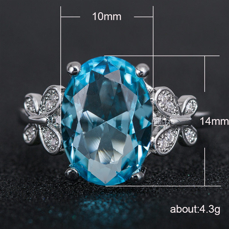 Eleganter Damenring mit großem blauem Zirkon & Schleifen-Design